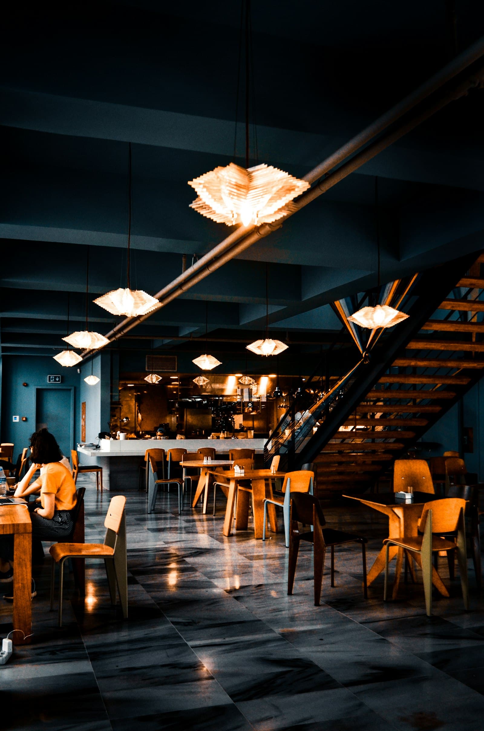 The dining room, lit by pendant lights over the open kitchen